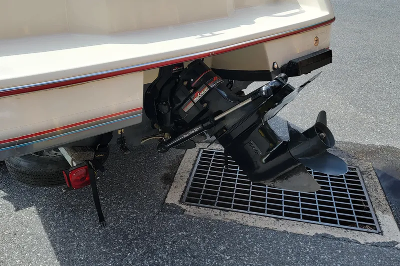 Slide: The Image of 1990 Bayliner 1850 Capri boat stern with outboard motor and propeller. - 2