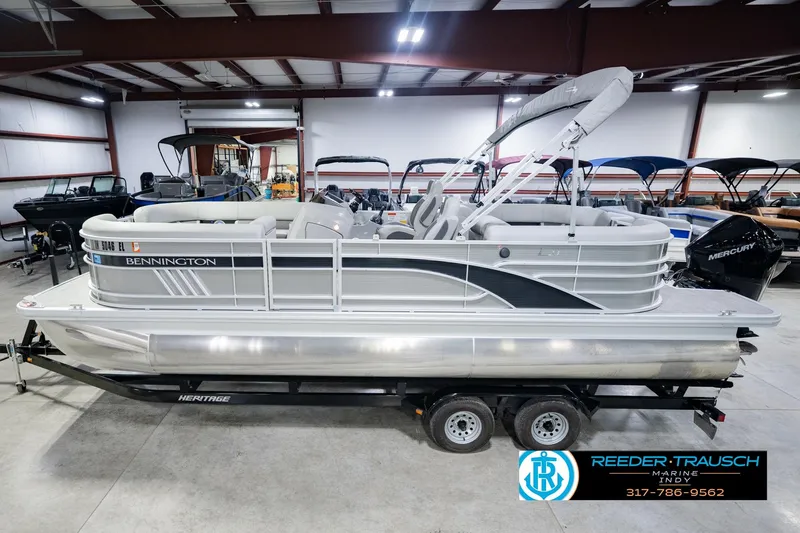 The Image of 2023 Bennington 23 LSR pontoon boat on trailer in indoor showroom. - 0