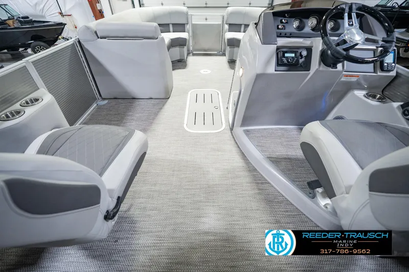 Slide: The Image of Interior of a 2023 Bennington 23 LSR pontoon boat with modern seating and steering console. - 24