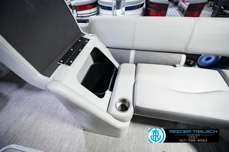 Slide: The Image of 2023 Bennington 23 LSR boat interior with storage compartment and cup holder. - 30