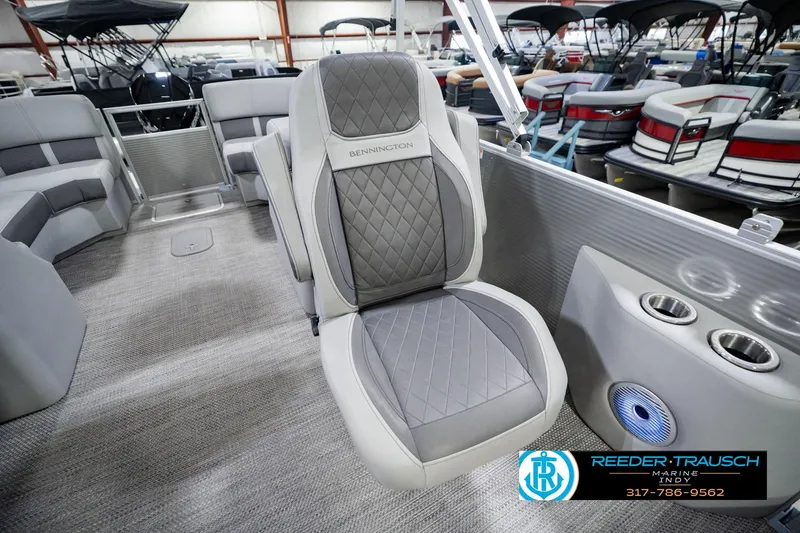 Slide: The Image of 2023 Bennington 23 LSR boat interior with gray seating and cup holders. - 32