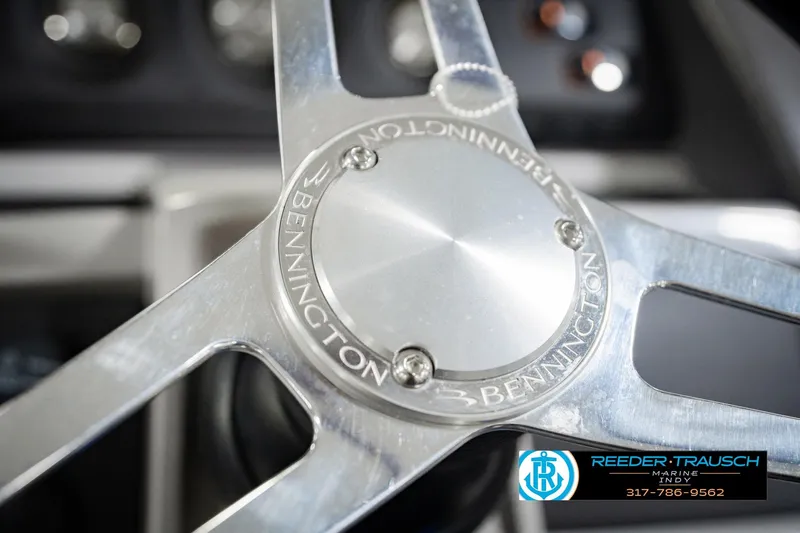Slide: The Image of Close-up of 2023 Bennington 23 LSR steering wheel with Reeder-Trausch Marine logo. - 38