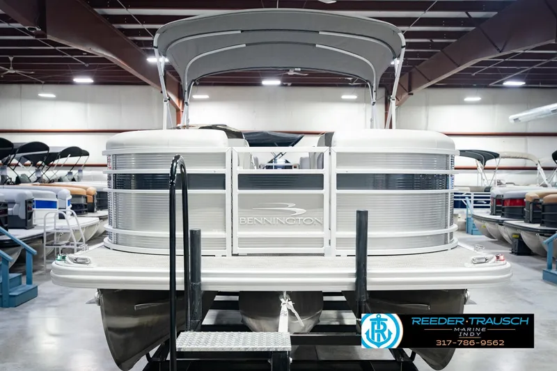 Slide: The Image of 2023 Bennington 23 LSR pontoon boat in showroom, front view with canopy. - 4