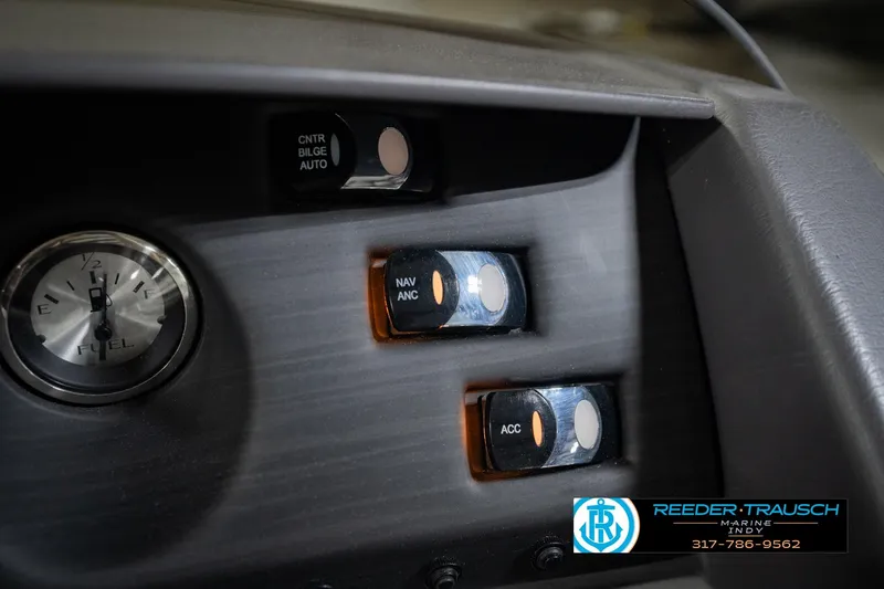 Slide: The Image of Dashboard controls of a 2023 Bennington 23 LSR boat with fuel gauge and switches. - 44