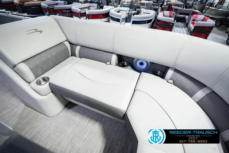 Slide: The Image of Luxurious seating on the 2023 Bennington 23 LSR pontoon boat, featuring elegant upholstery and cup holders. - 52