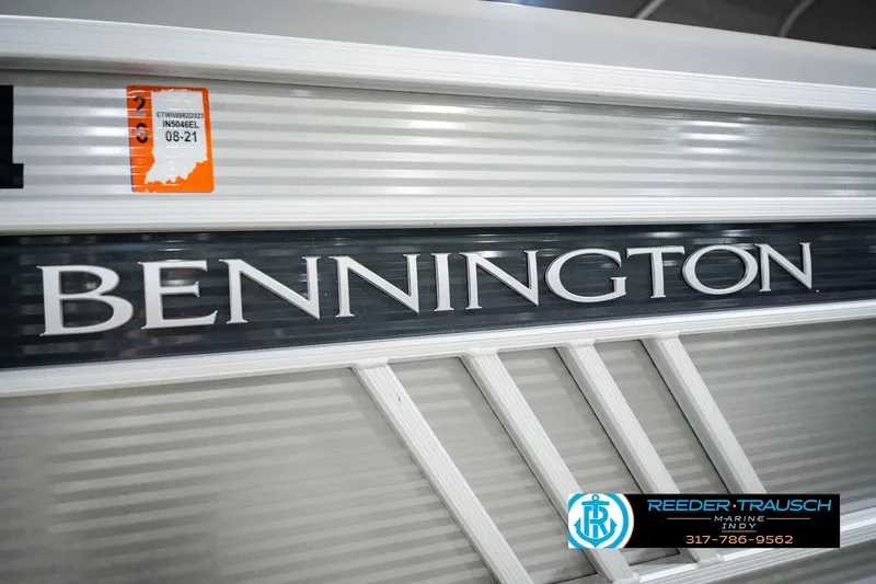 Slide: The Image of 2023 Bennington 23 LSR boat with dealership branding and registration sticker. - 60