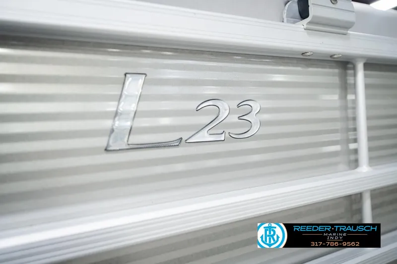 Slide: The Image of 2023 Bennington 23 LSR boat detail with Reeder Trausch Marine logo. - 61