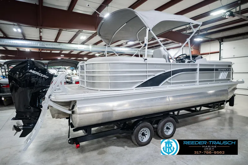 Slide: The Image of 2023 Bennington 23 LSR pontoon boat with Mercury engine on trailer in showroom. - 8