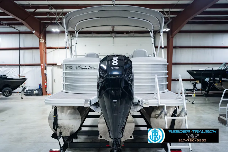 Slide: The Image of 2023 Bennington 23 LSR pontoon boat with 200 HP engine in a showroom. - 9