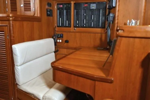 Slide: The Image of Luxurious wooden interior of 2012 Passport Vista 545 Center Cockpit yacht with navigation panel. - 10
