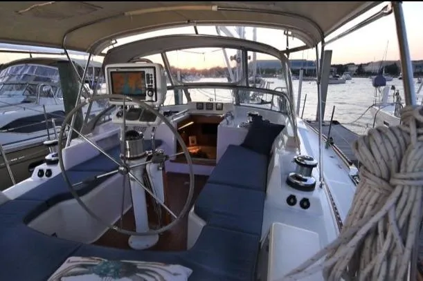 Slide: The Image of Center cockpit of 2012 Passport Vista 545 sailboat at sunset, featuring navigation equipment. - 22
