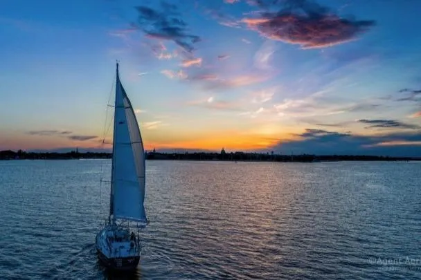 Slide: The Image of Sailboat "Passport Vista 545 Center Cockpit" cruising at sunset, 2012 model, on tranquil waters. - 26