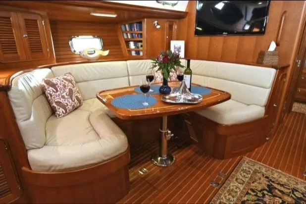 Slide: The Image of Luxurious interior of 2012 Passport Vista 545 Center Cockpit yacht with elegant dining area. - 4