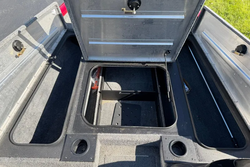 Slide: The Image of 2024 Tracker Pro Team 175 TXW boat storage compartments open, showcasing interior space. - 12