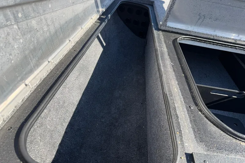 Slide: The Image of 2024 Tracker Pro Team 175 TXW boat storage compartment, open and empty. - 13