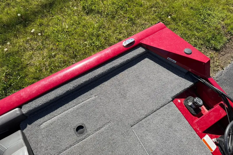 Slide: The Image of 2024 Tracker Pro Team 175 TXW boat deck with red trim and gray carpet. - 15