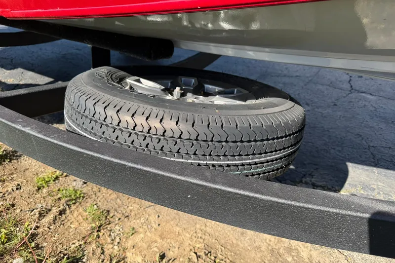 Slide: The Image of 2024 Tracker Pro Team 175 TXW trailer with spare tire mounted underneath. - 18