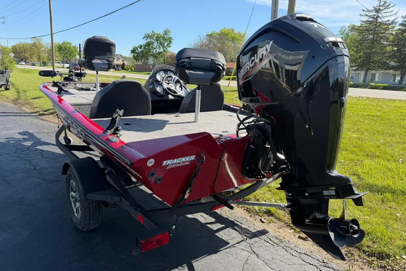 Slide: The Image of 2024 Tracker Pro Team 175 TXW boat with Mercury engine, parked on a sunny day. - 3