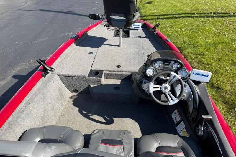 Slide: The Image of 2024 Tracker Pro Team 175 TXW boat interior with steering console and seating. - 5