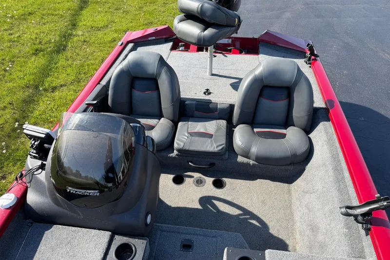 Slide: The Image of 2024 Tracker Pro Team 175 TXW boat interior with gray seating and red accents. - 6