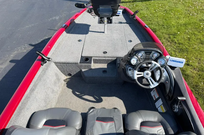 Slide: The Image of 2024 Tracker Pro Team 175 TXW boat interior with steering console and seating. - 7