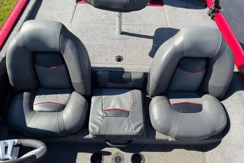 Slide: The Image of 2024 Tracker Pro Team 175 TXW boat seats, featuring gray upholstery with red accents. - 8