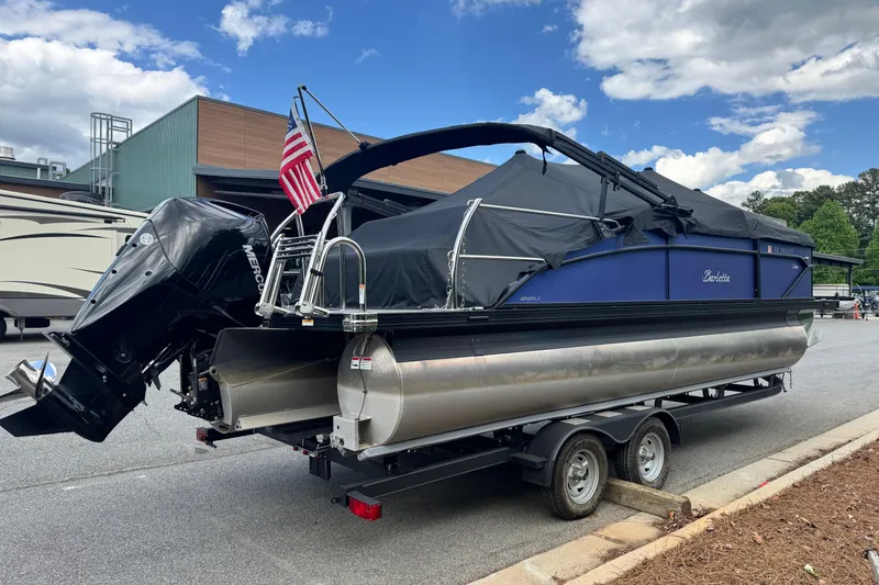 Slide: The Image of 2023 Barletta C22U pontoon boat on trailer with cover. - 2