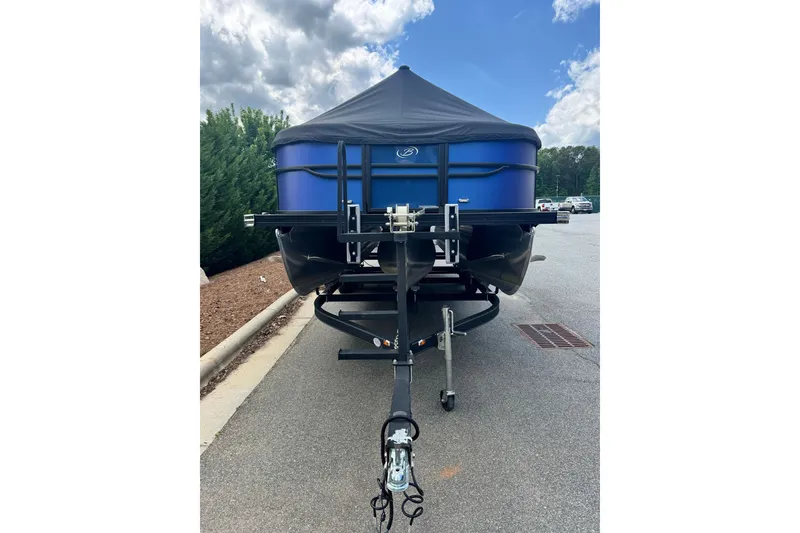 Slide: The Image of 2023 Barletta C22U pontoon boat on trailer, blue hull, covered. - 4