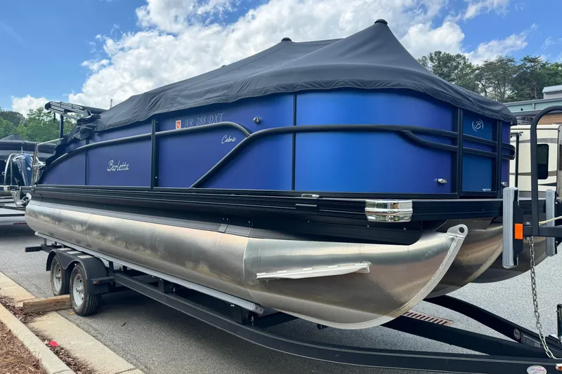 Slide: The Image of 2023 Barletta C22U pontoon boat on trailer, blue and black. - 3