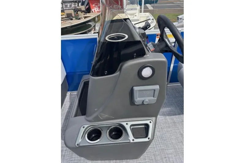 Slide: The Image of 2026 Sun Tracker Party Barge 16 DLX console with steering wheel and cup holders. - 8