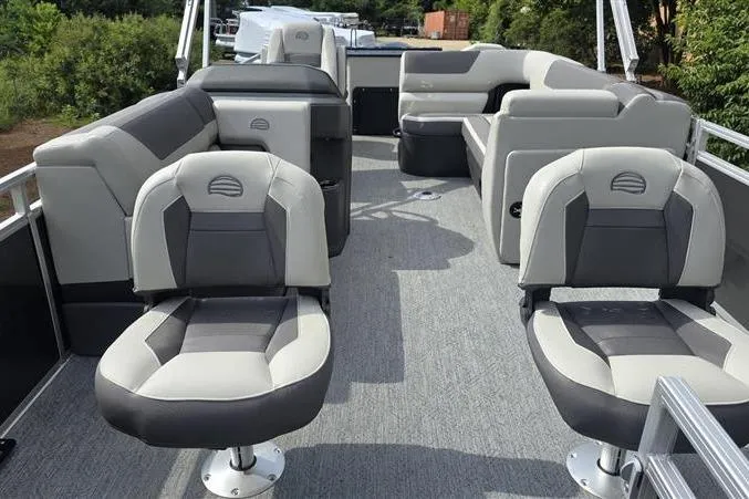 Slide: The Image of 2026 Sun Tracker Fishin' Barge 22 DLX interior with plush seating and spacious layout. - 7