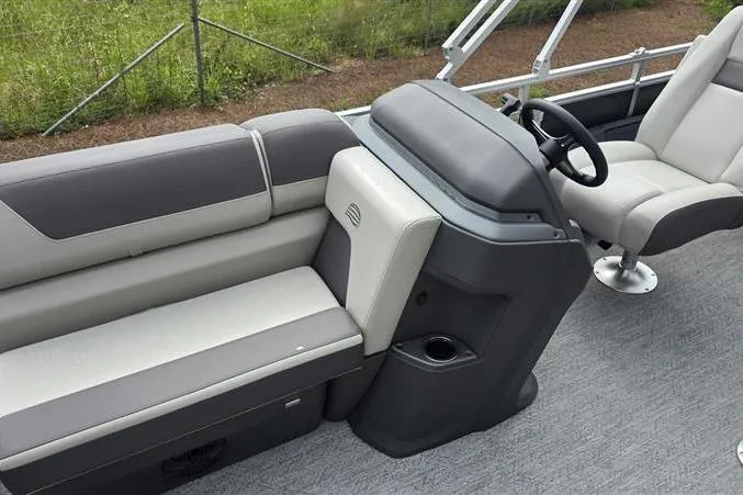Slide: The Image of Interior of 2026 Sun Tracker Fishin' Barge 22 DLX with seating and steering console. - 8