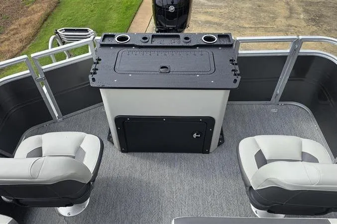 Slide: The Image of 2026 Sun Tracker Fishin' Barge 22 DLX interior with seating and fishing station. - 4