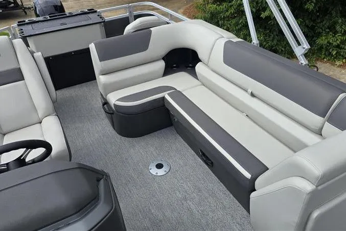 Slide: The Image of 2026 Sun Tracker Fishin' Barge 22 DLX interior with gray seating and carpeted floor. - 6