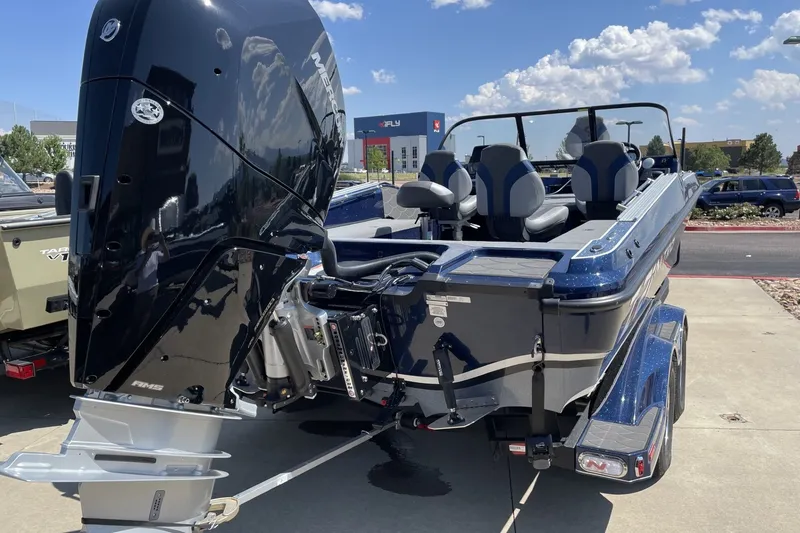 Slide: The Image of 2026 Nitro ZV21 Pro boat with powerful engine, parked outdoors under a clear sky. - 1