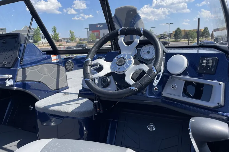 Slide: The Image of Steering console of 2026 Nitro ZV21 Pro boat under a clear blue sky. - 3