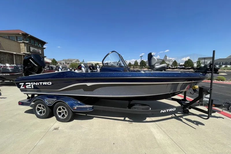 The Image of 2026 Nitro ZV21 Pro boat on trailer, parked outdoors under clear blue sky. - 0