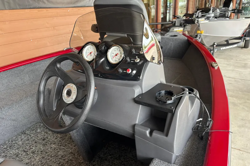 Slide: The Image of 2026 Tracker Super Guide V-16 SC boat dashboard with steering wheel and gauges. - 6