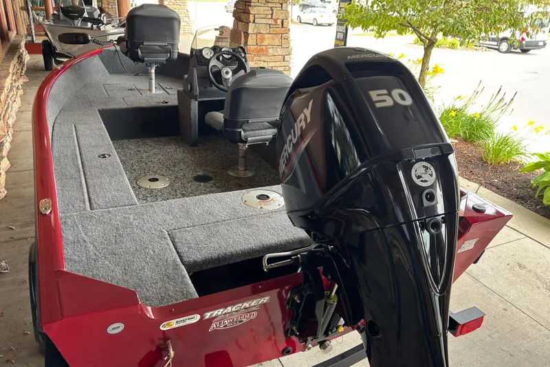 Slide: The Image of 2026 Tracker Super Guide V-16 SC boat with Mercury 50 engine, parked outdoors. - 7