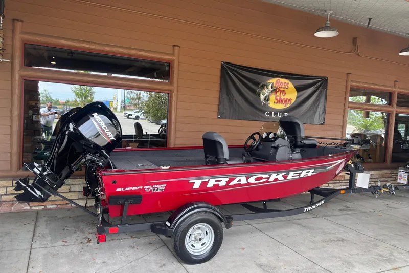 Slide: The Image of 2026 Tracker Super Guide V-16 SC boat displayed at Bass Pro Shops. - 2