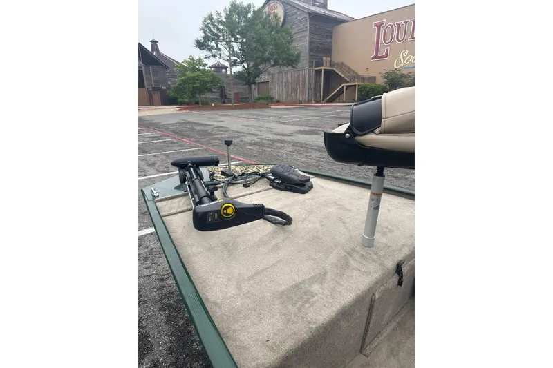 Slide: The Image of 2026 Tracker Bass Tracker Classic Limited boat with trolling motor in a parking lot. - 4