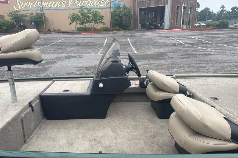 Slide: The Image of 2026 Tracker Bass Tracker Classic Limited boat interior with beige seats in parking lot. - 5