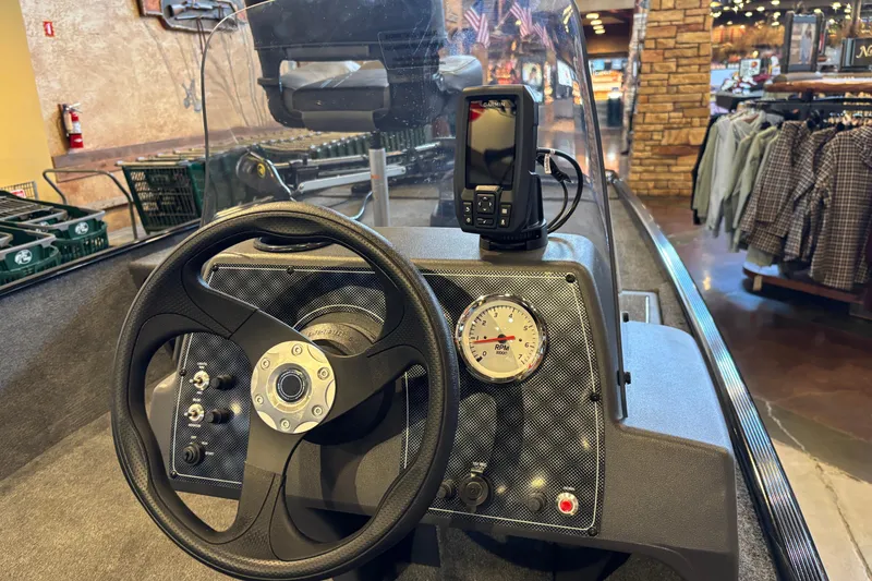 Slide: The Image of 2026 Tracker Bass Tracker Classic XL boat dashboard with steering wheel and navigation display. - 10