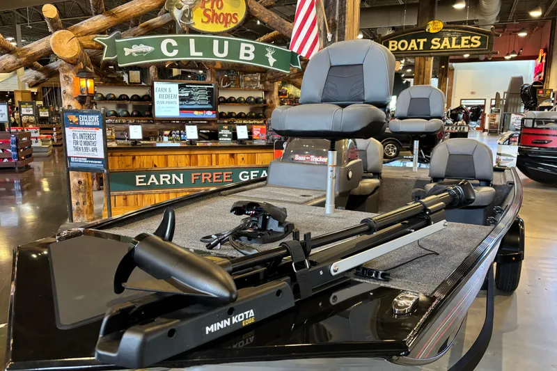 Slide: The Image of 2026 Tracker Bass Tracker Classic XL boat displayed at a showroom with promotional signage. - 7