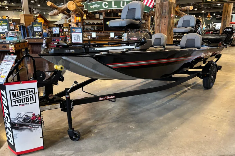 Slide: The Image of 2026 Tracker Bass Tracker Classic XL boat displayed indoors on a trailer. - 8