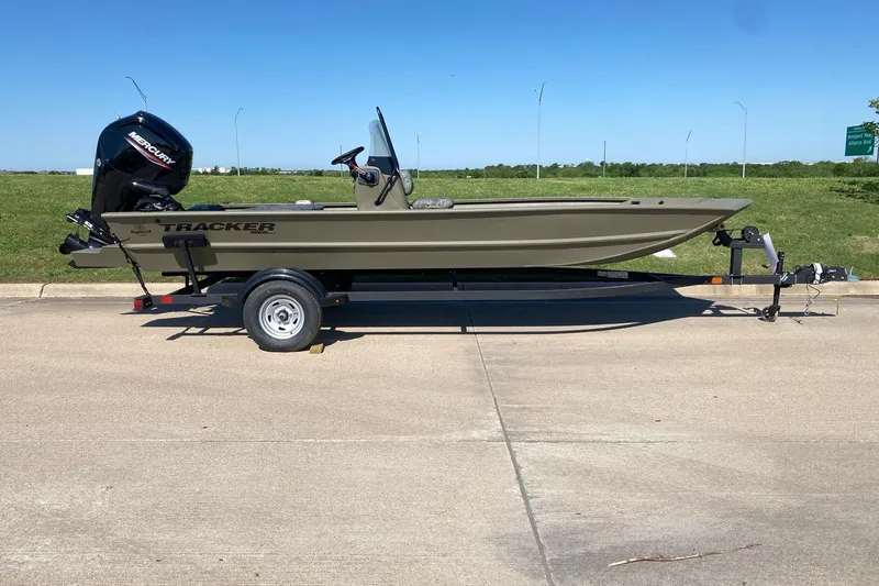The Image of 2026 Tracker Grizzly 1860 CC boat on trailer, parked outdoors. - 1