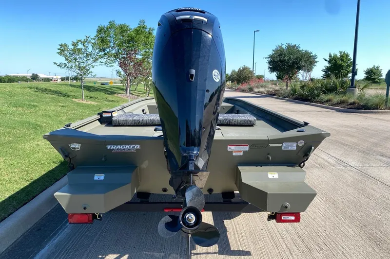 Slide: The Image of 2026 Tracker Grizzly 1860 CC boat with outboard motor on a sunny day. - 12