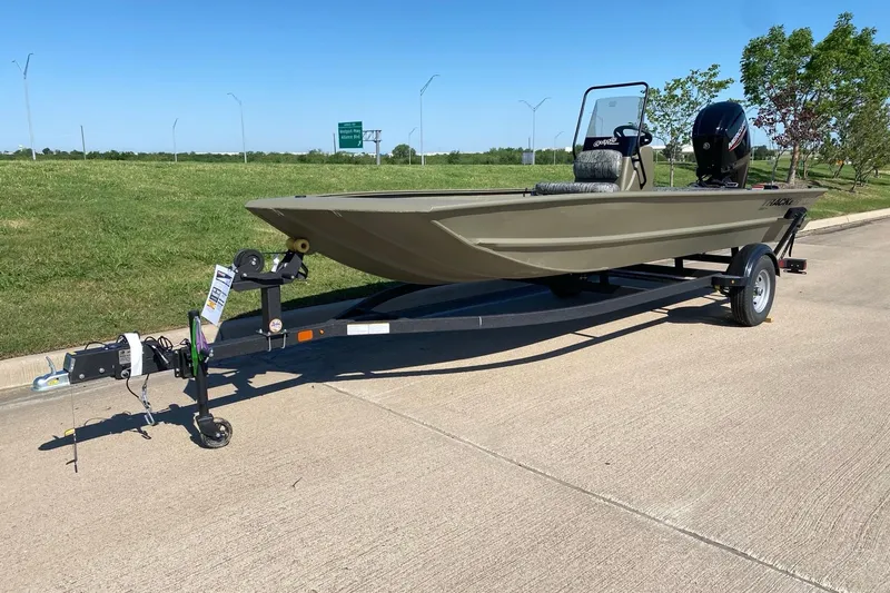 Slide: The Image of 2026 Tracker Grizzly 1860 CC boat on trailer, parked on a sunny road. - 4