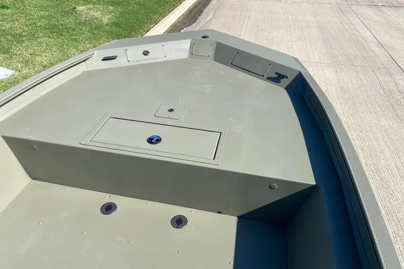 Slide: The Image of 2026 Tracker Grizzly 1860 CC boat deck, featuring storage compartments and a clean, spacious layout. - 7