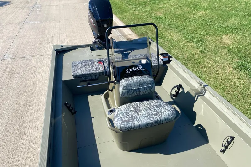 Slide: The Image of 2026 Tracker Grizzly 1860 CC boat with camo seats and Mercury engine. - 8